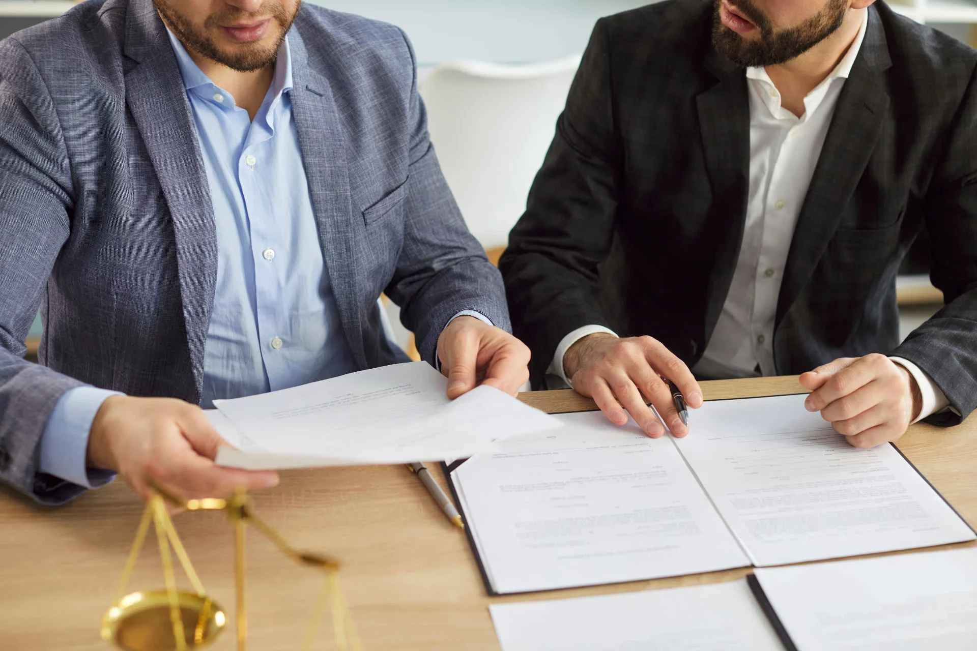 Advisor and business owner reviewing permanent life insurance Canada paperwork at a desk