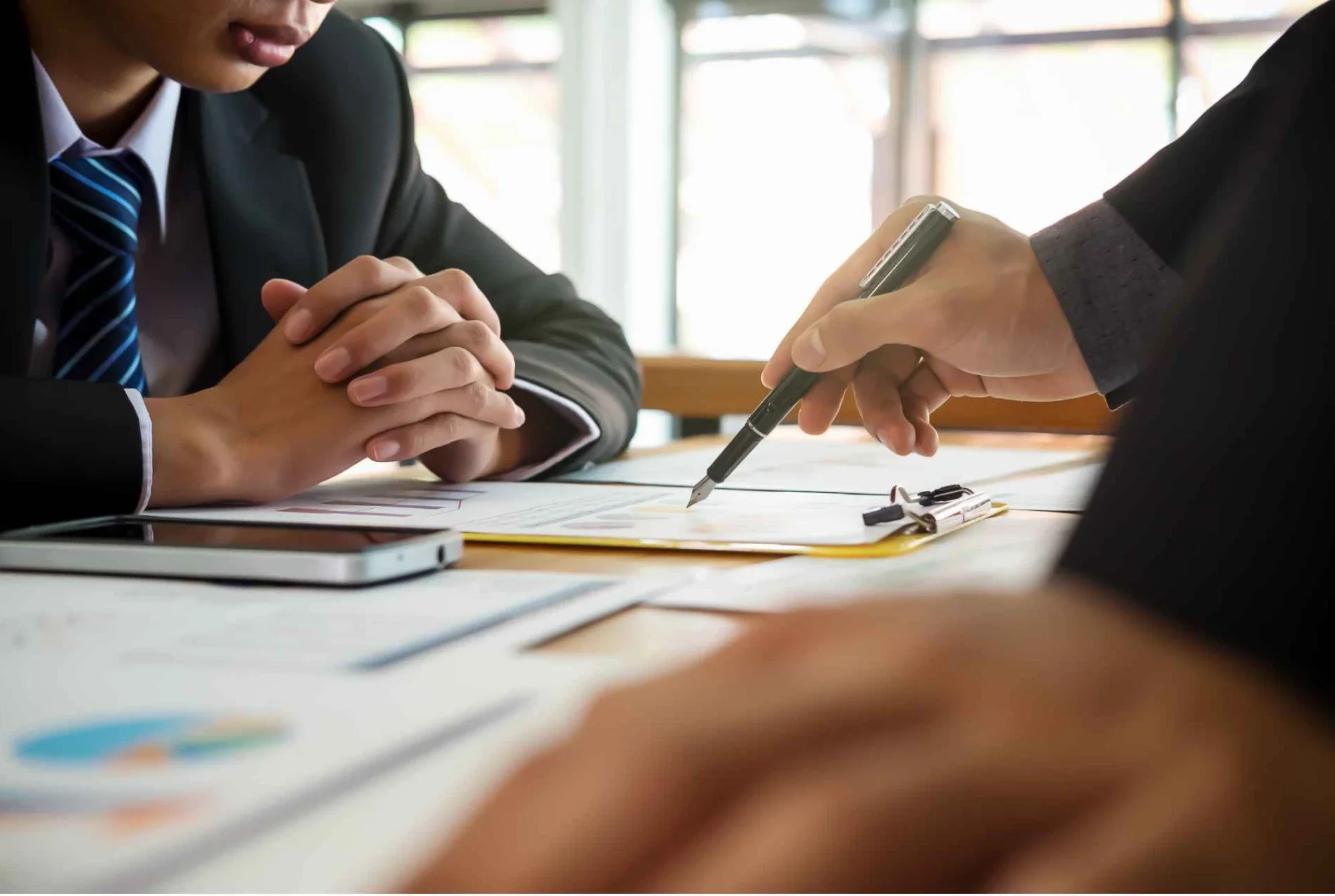 Advisor and incorporated business owner reviewing a corporate structure document.