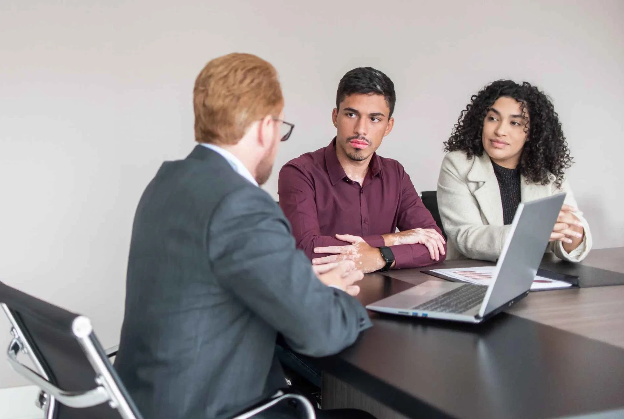 Financial advisor reviewing a corporate investment account portfolio with a client.