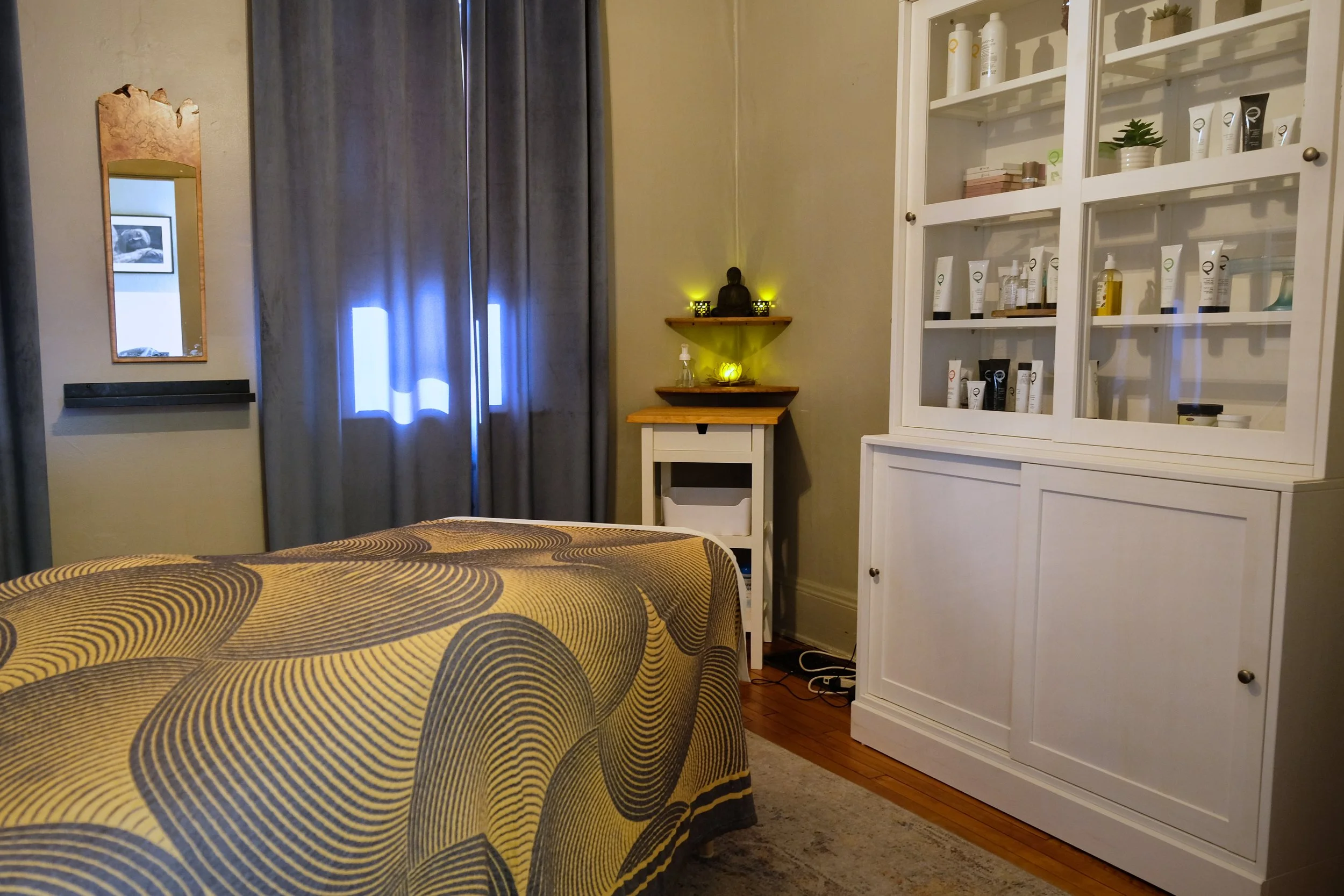 a peaceful treatment room, with lit candles