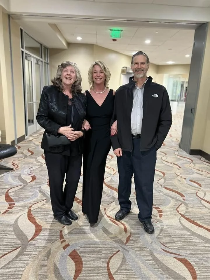 Standing image of Ross, Jill and Lee at a theater