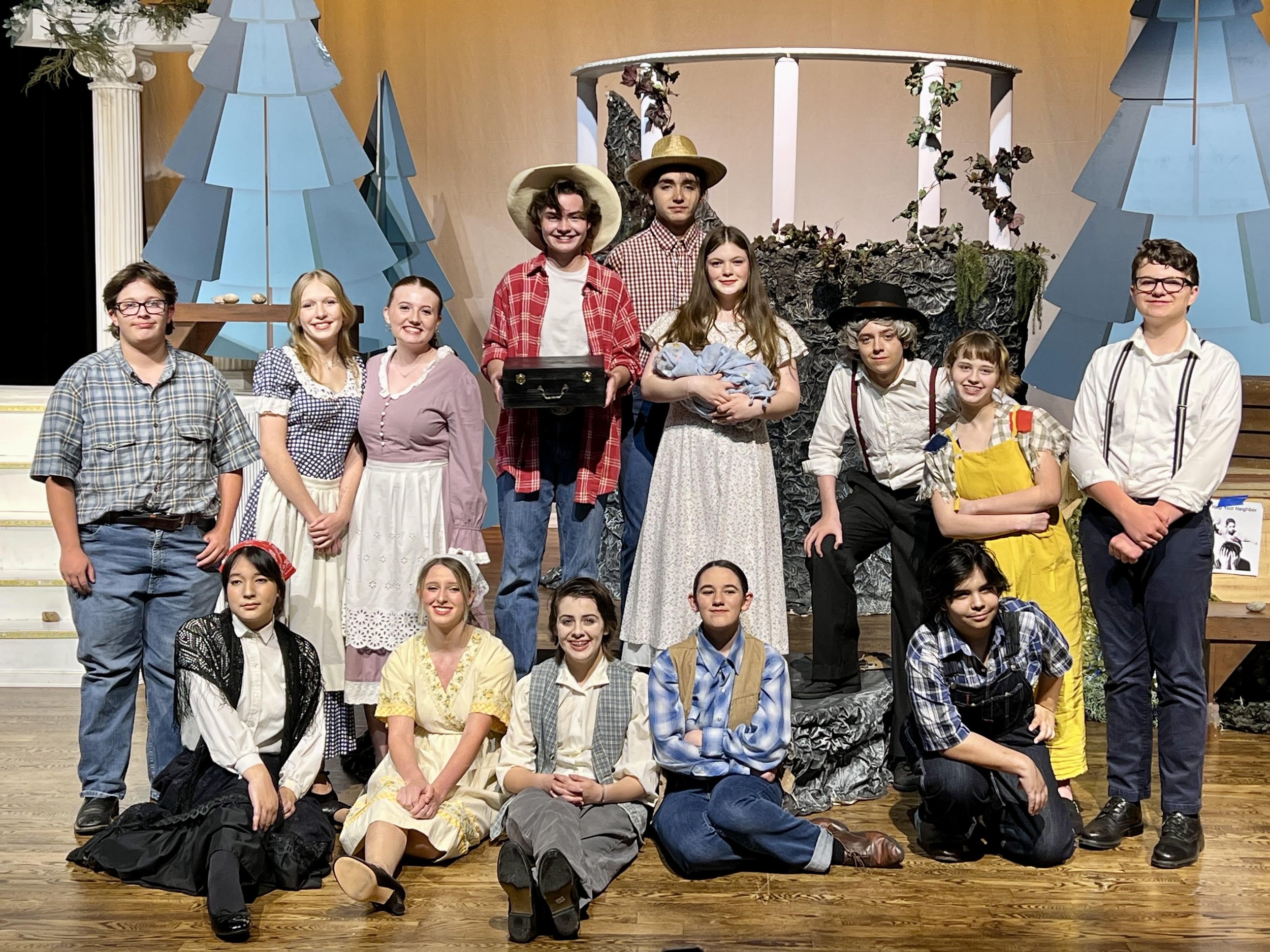 Student group onstage posing after a show
