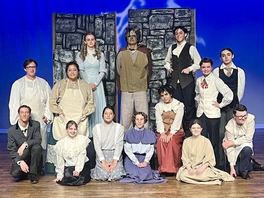 Student group onstage posing after a show