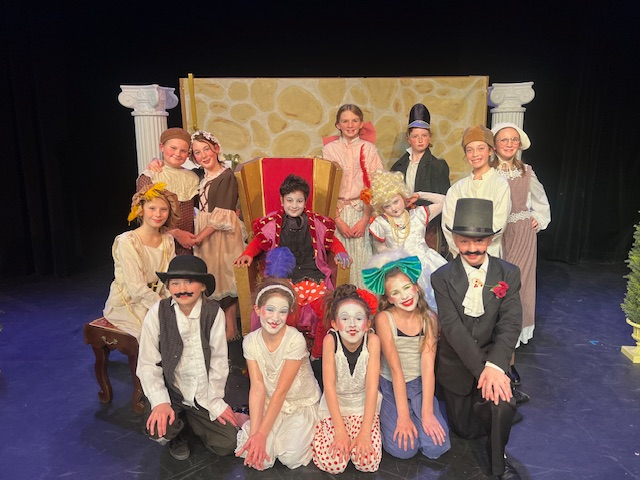 Young actors on stage posing