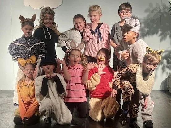 Young actors onstage in costume