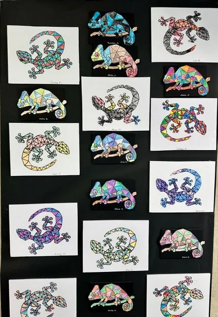 Colored geometric lizard artwork on white paper, arranged on a black background.