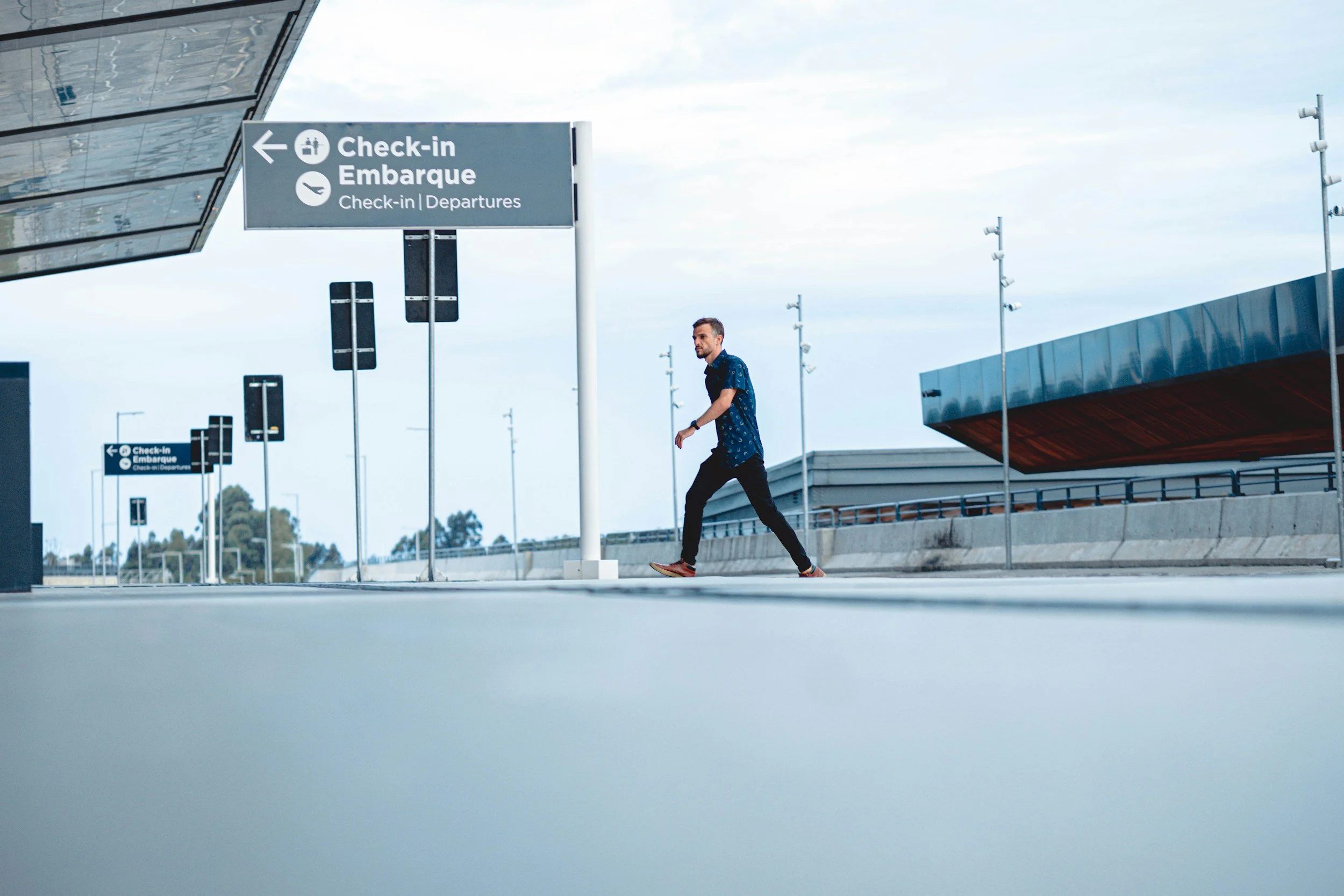 Man walking into an airport to check in at the airport. Mental health blog talks about checking in with mental health warning signs.