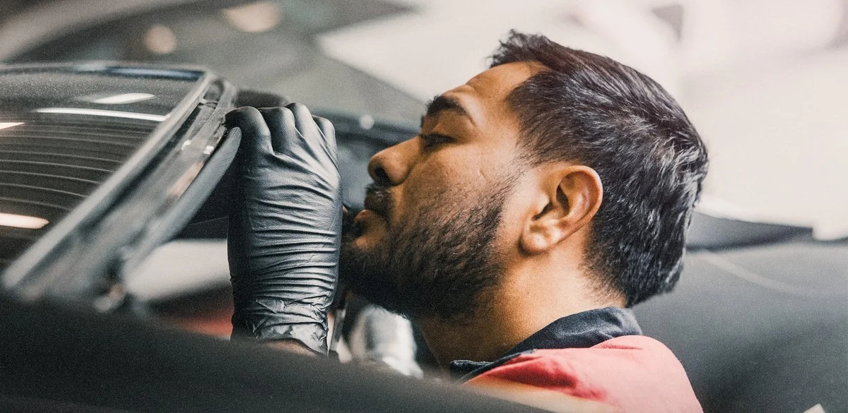 Technician checking body panel fit during auto body repair in Oxnard, CA