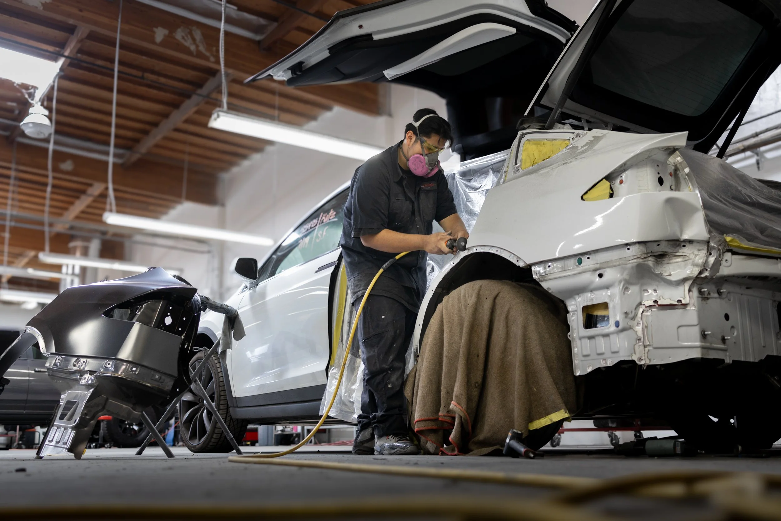 Technician performing car accident repair on a vehicle in Oxnard
