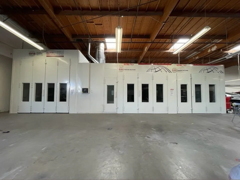 inside Prestige Bodyworks Auto Collision's large vehicle paint booth in Oxnard