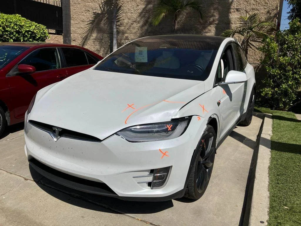 Tesla Model Y front-end body damage before collision repair in Oxnard