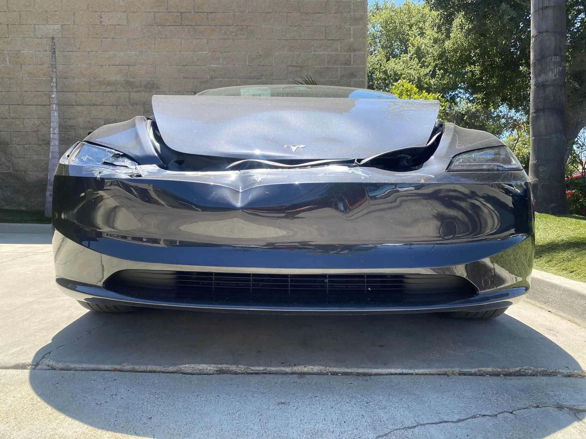 Tesla with front bumper and front-end collision damage in Oxnard