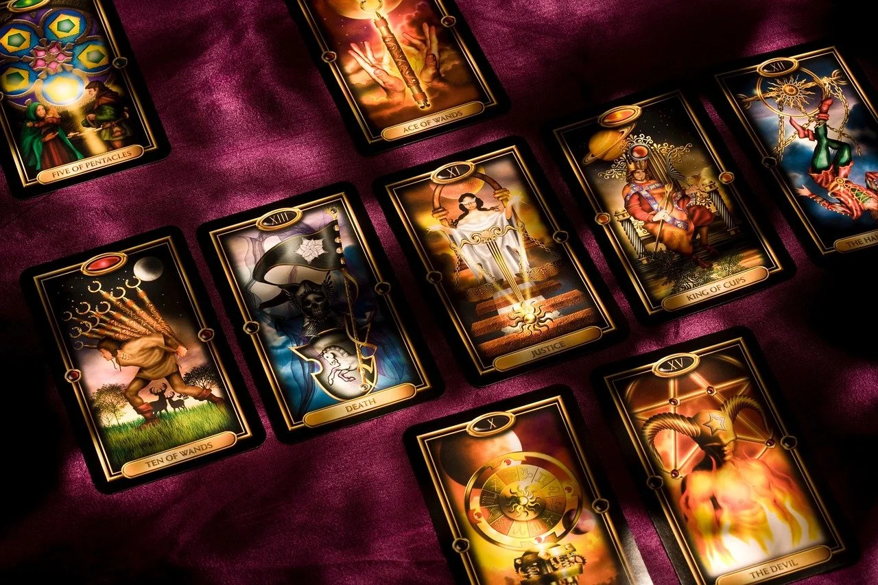 Tarot spread on velvet surface used for psychic readings, intuitive guidance, and spiritual connection through divination. This symbolizes divine guidance, intuition and insight during a spiritual reading