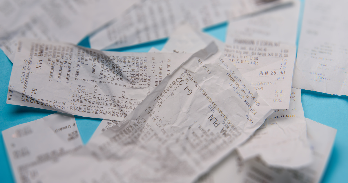 Pile of crumpled receipts symbolizing disorganized paperwork and mental clutter faced by small subcontractors.