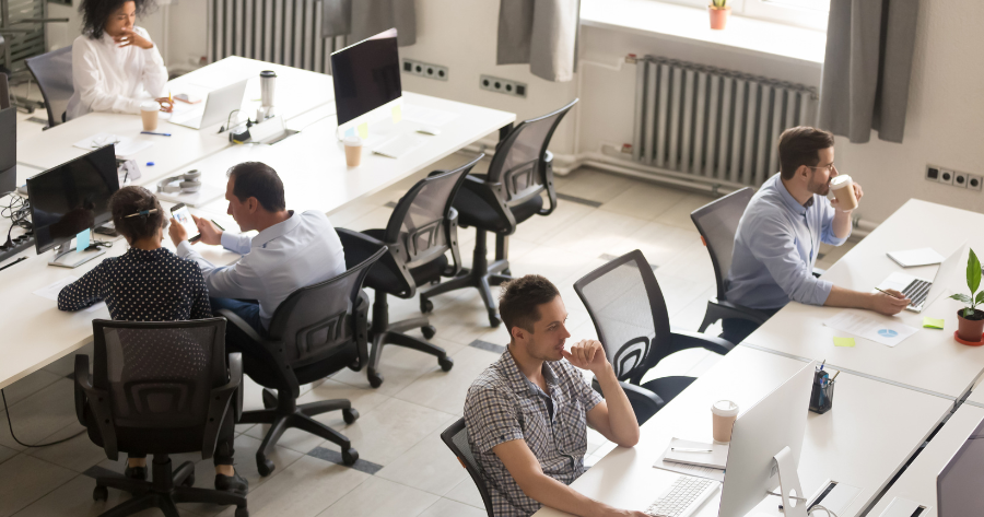 Team of professionals working in a shared office space, representing collaboration, momentum, and business readiness in progress.