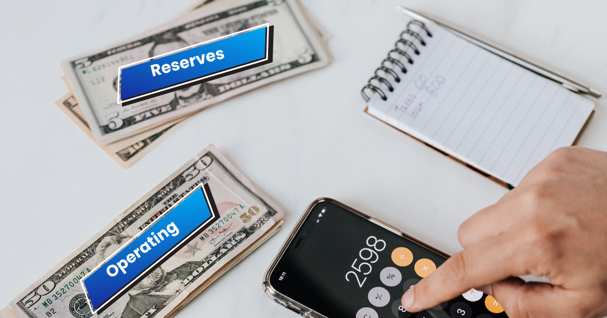 Cash divided into operating and reserve categories next to a calculator and notepad, illustrating how a small business can separate funds by purpose.