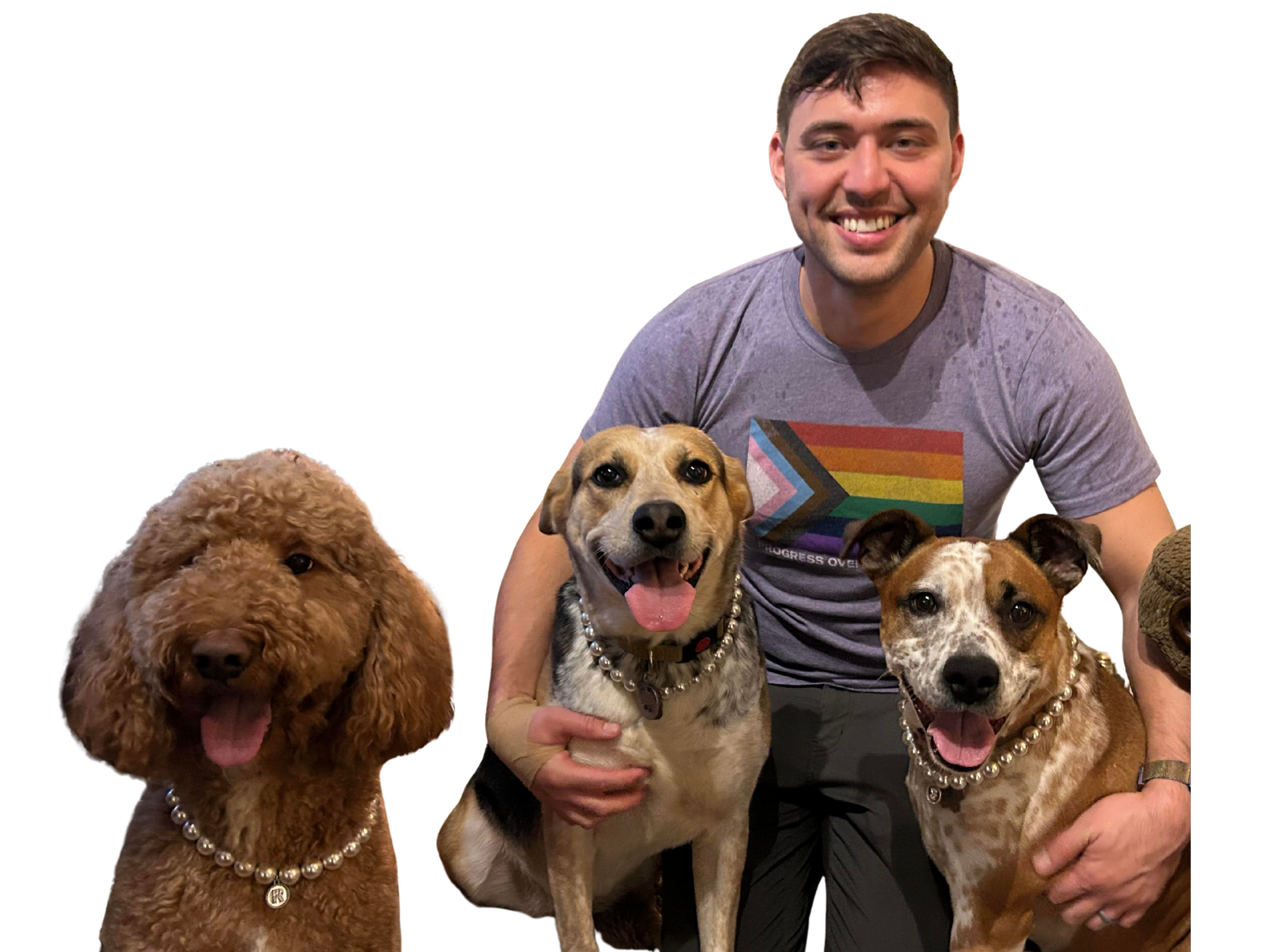 Our founder, Jon, wearing a shirt with an LGBTQ flag, poses with his three dogs, each wearing a faux pearl necklace
