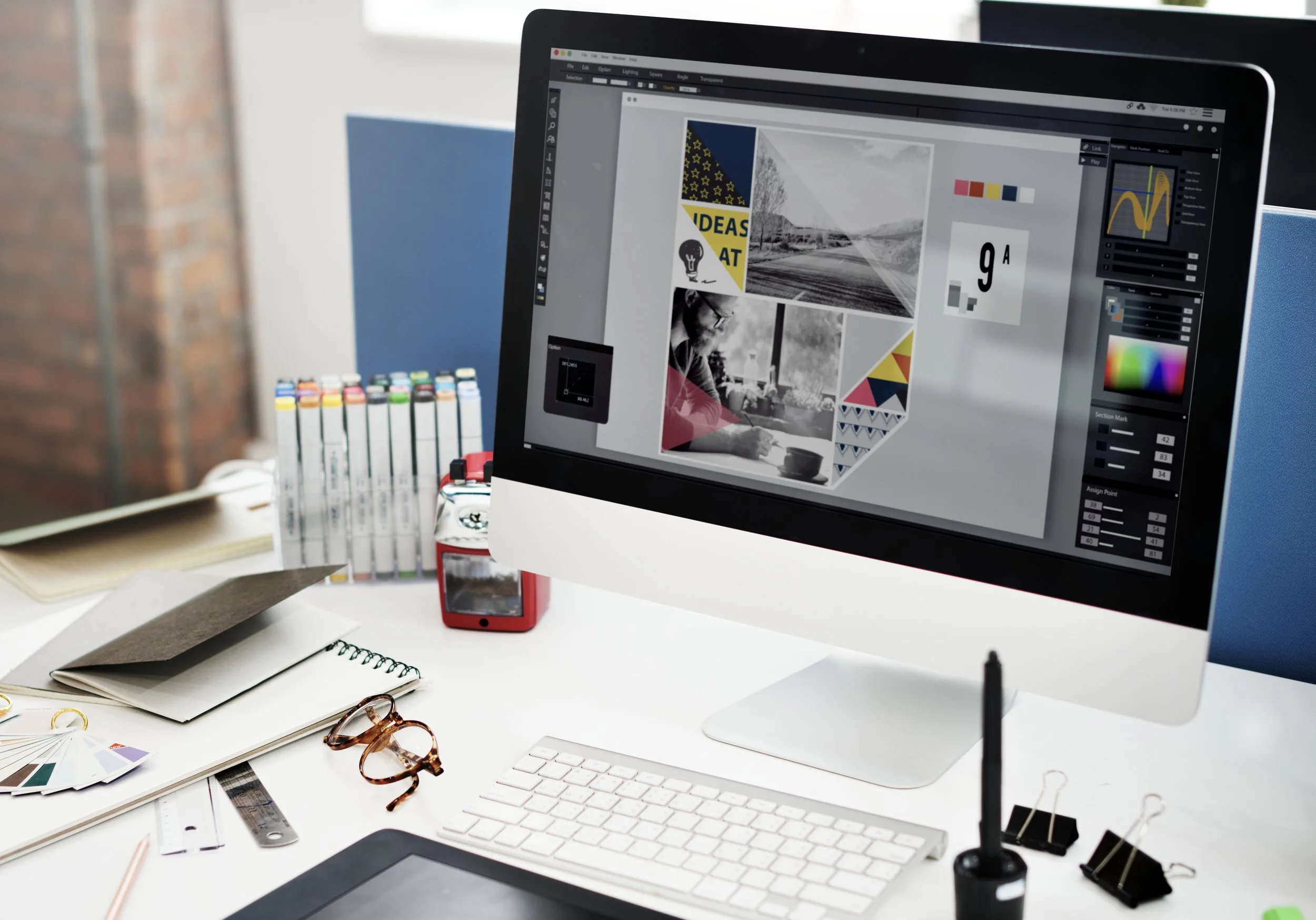 Someone using a document creation and graphic design program on an iMac