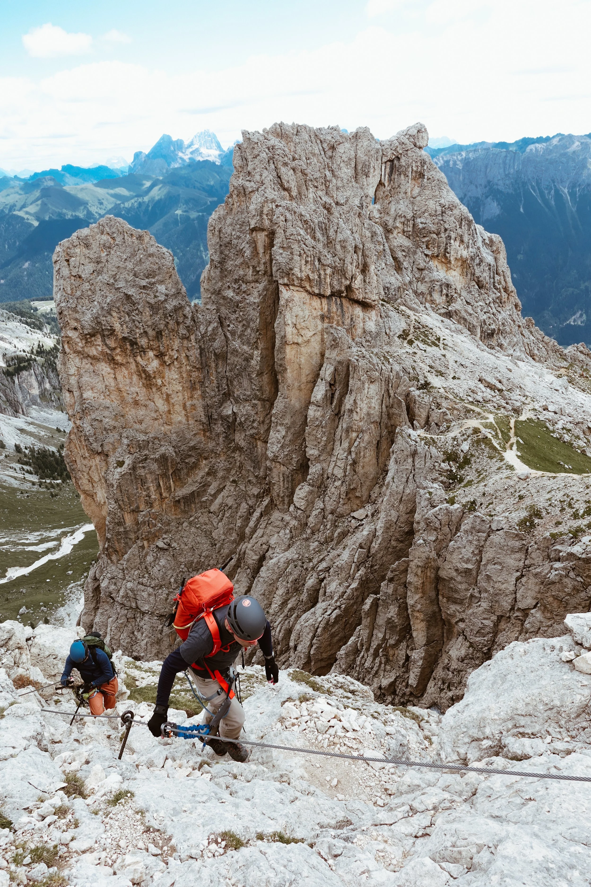 Two climbers during a via ferrata in the Catinaccio mountain range, in the Dolomites, following their mountain guide Filippo Barbieri.
