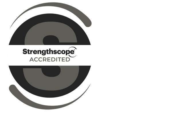 A circular badge with a black outer ring, a white band across the middle, and a large gray S in the centre. The white band contains the text 'Strengthscope ACCREDITED'.
