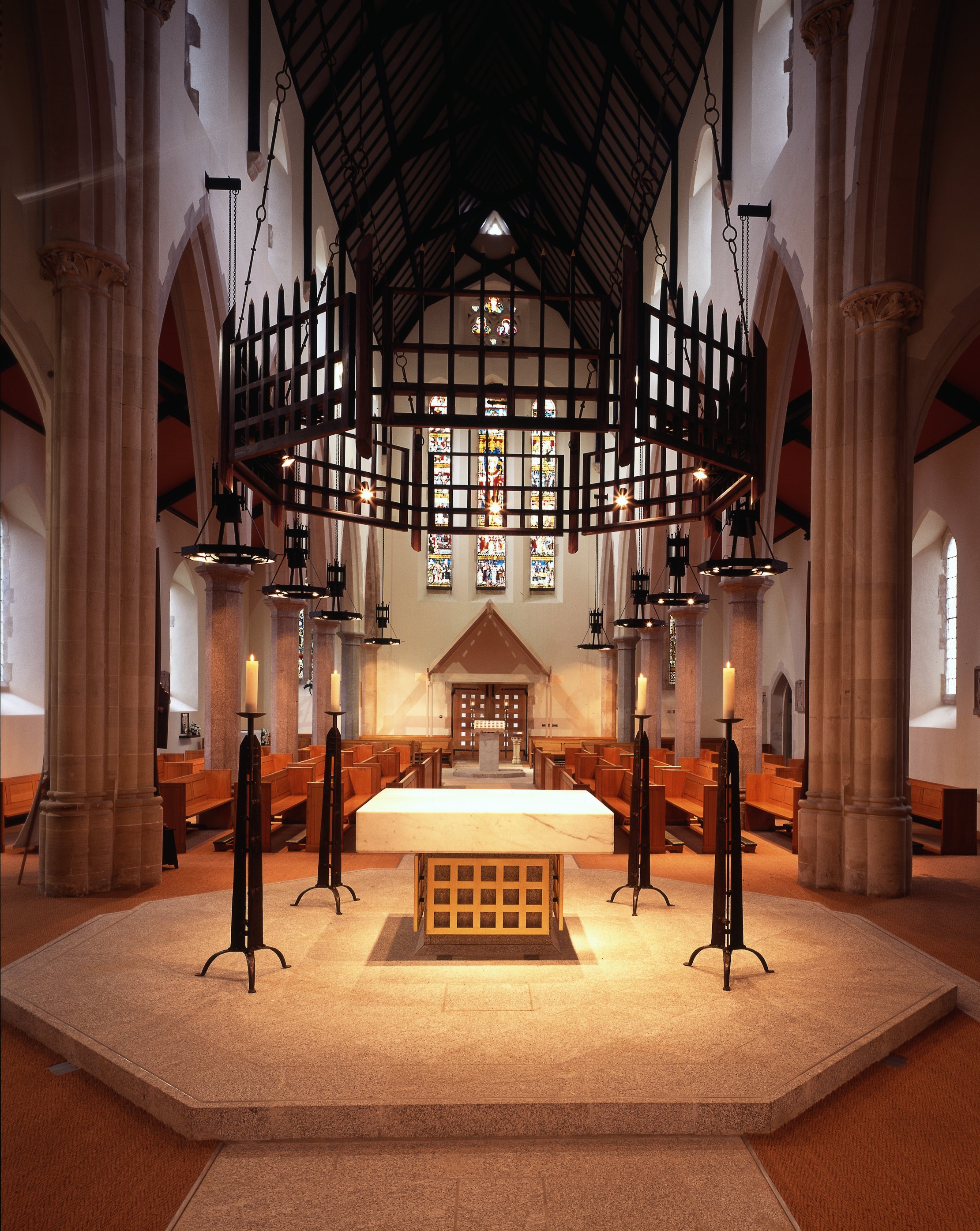 Ecclesiastical ironworks (candlesticks and corona design Anthony Harrison, detail and execution JC,, 12 chandeliers designed AH and JC, executed JC, 68 metres chain to hang corona, JC)