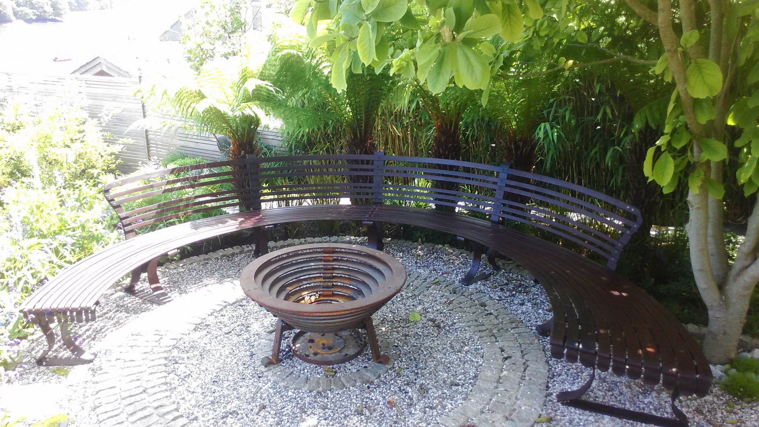 Semi circular garden seat and fire basket (JC)
