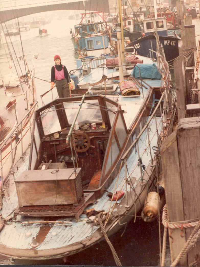 Sylvia up against the wall in Weymouth Harbour, 1986, having just received her new owners on board
