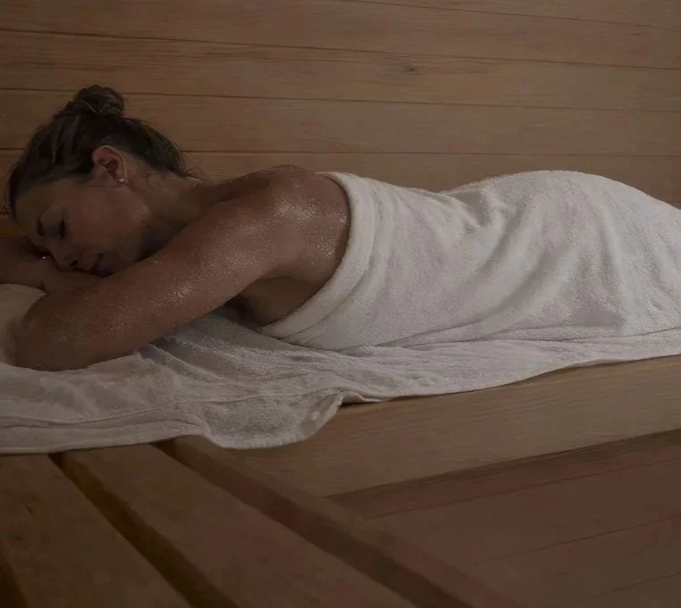 A woman in a traditional finnish sauna.