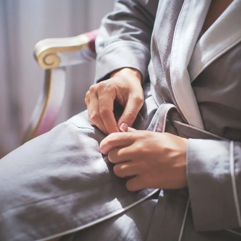A guest relaxing in a premium satin robe at The Spa at Yellow Creek, preparing for a luxury wellness treatment.