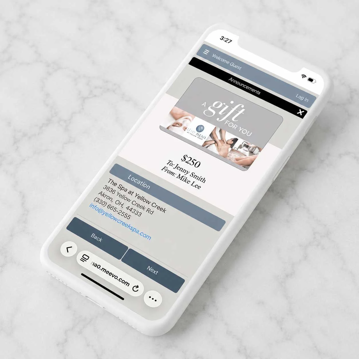 A smartphone displays a gift card purchase screen for a spa, showing a $250 gift card for The Spa at Yellow Creek, located in Akron, Ohio, with contact details and navigation buttons.
