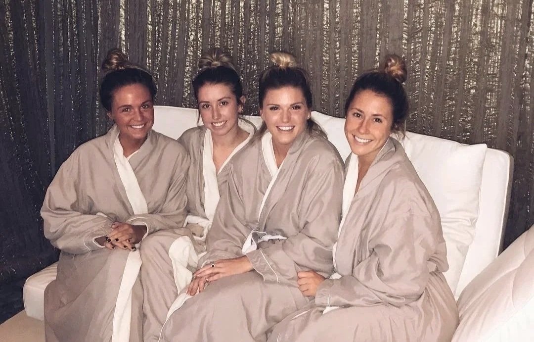 A group of friends enjoying a private bridal spa party in luxury robes at The Spa at Yellow Creek.