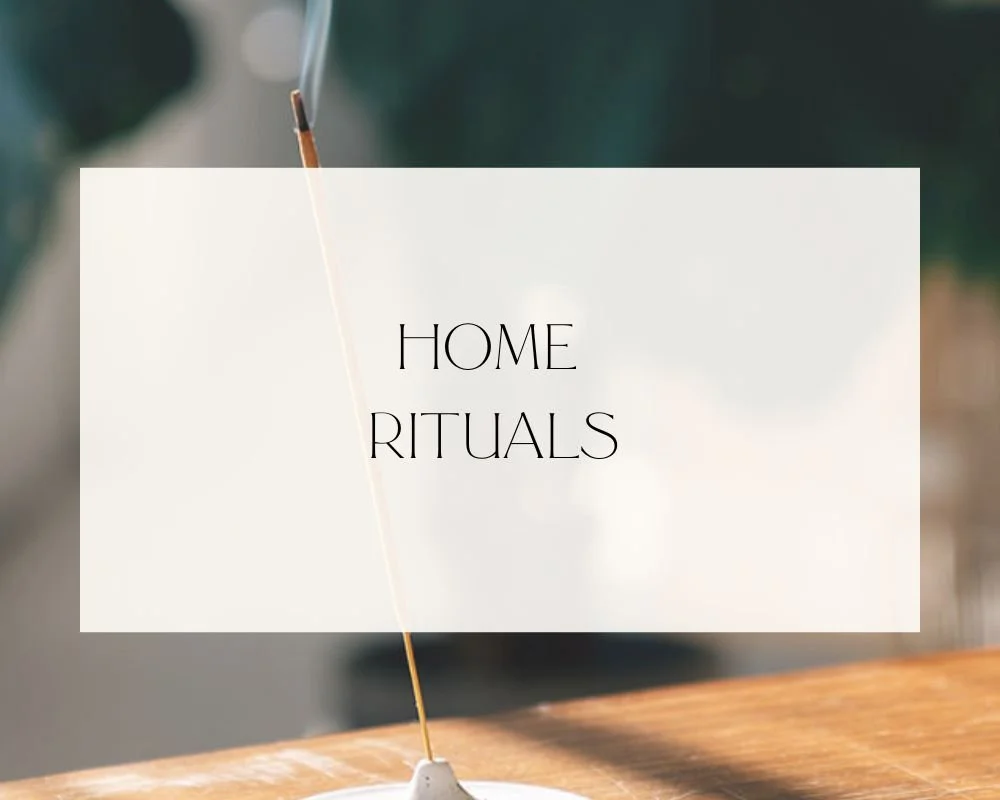 A close-up of an incense stick burning with smoke rising in a home environment. Overlaid text reads 'Home Rituals'.