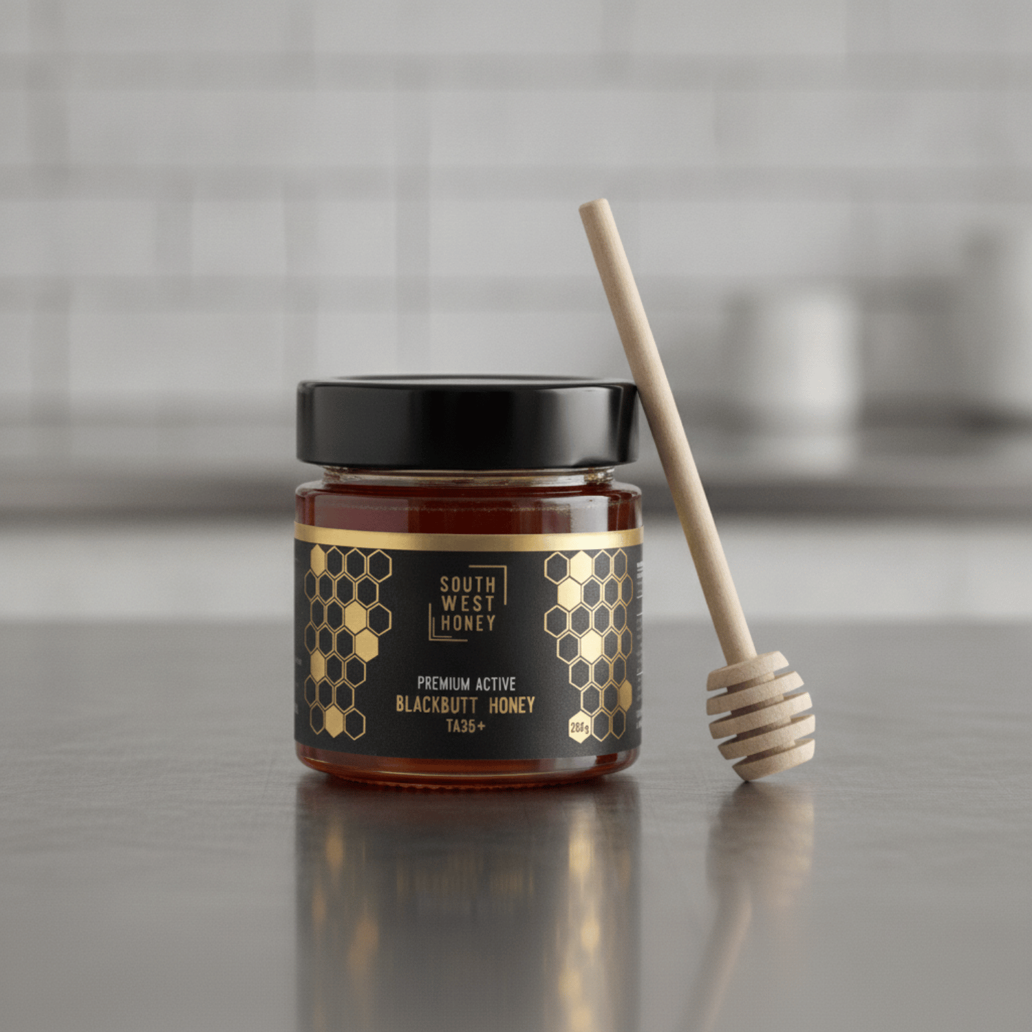 Western Australian Blackbutt honey TA35+ on a kitchen bench with a honey dipper