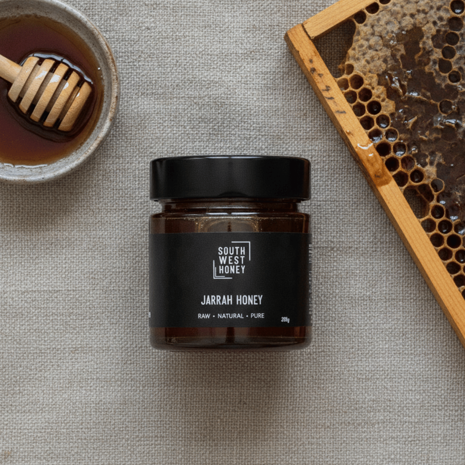 Western Australian Jarrah honey flat lay with honey and honeycomb