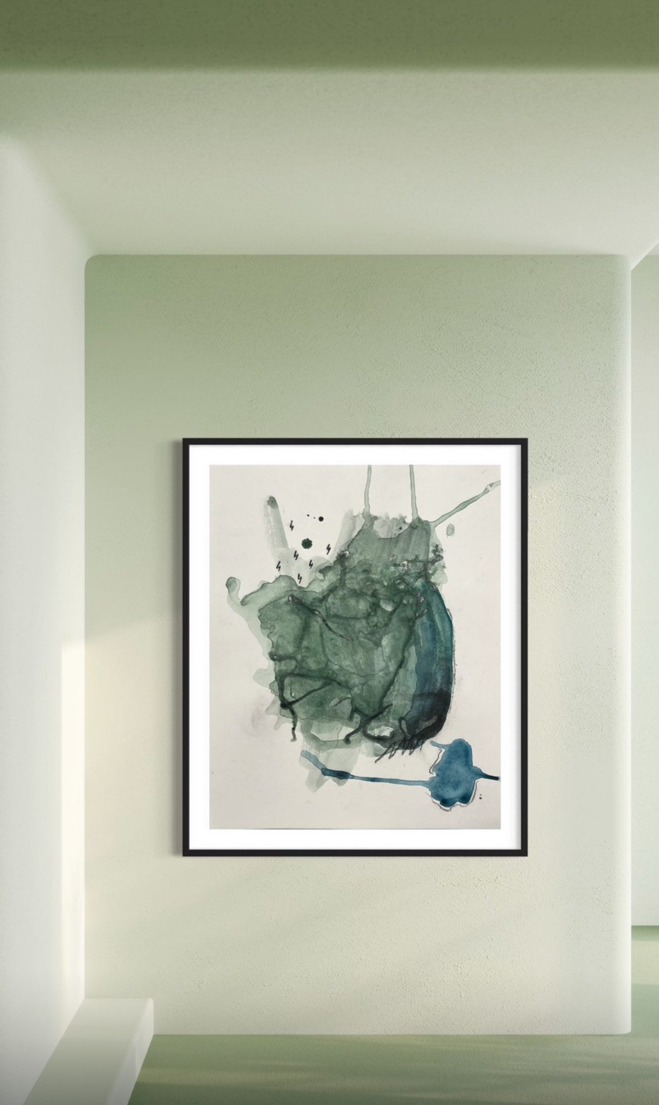 An abstract watercolor painting with shades of gray, green, and blue, framed and hung on a light green wall in a gallery setting.