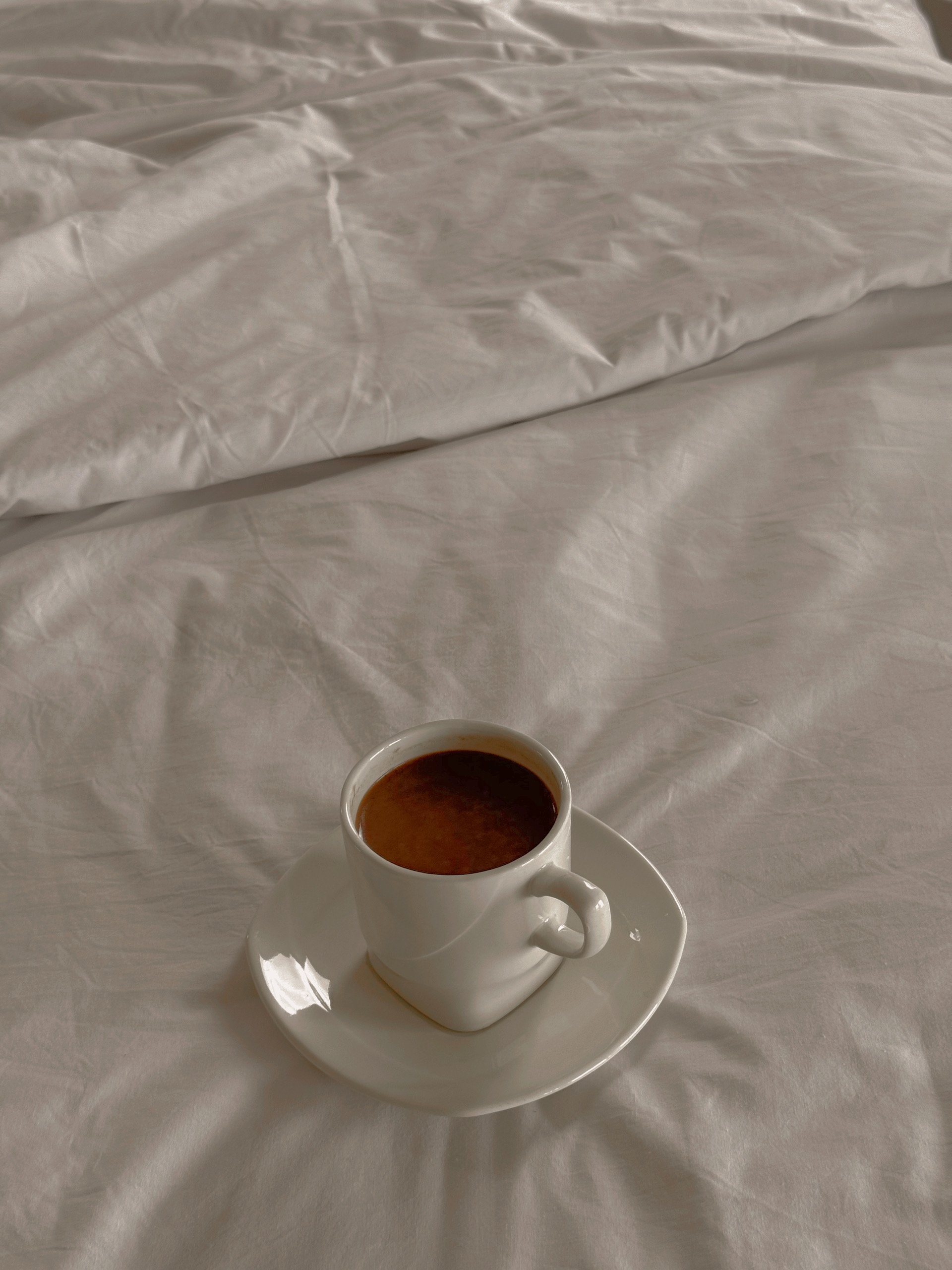 a cup of fresh coffee awaiting a traveler on their bed with fresh linens in Puerto Escondido Mexico