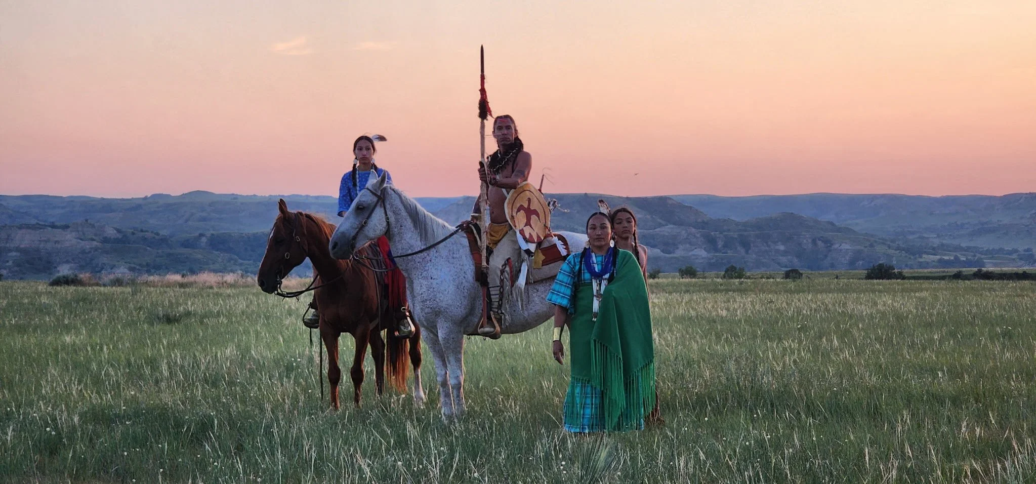 Native Americans and horses at sunset