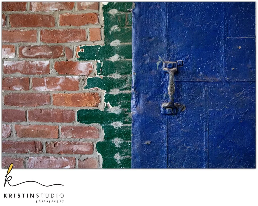 The harshness of heavy metal fire doors and the grand scale of tall brick walls soothed by the calming, grounding colors of blue and green. 💚 💙 🧱
