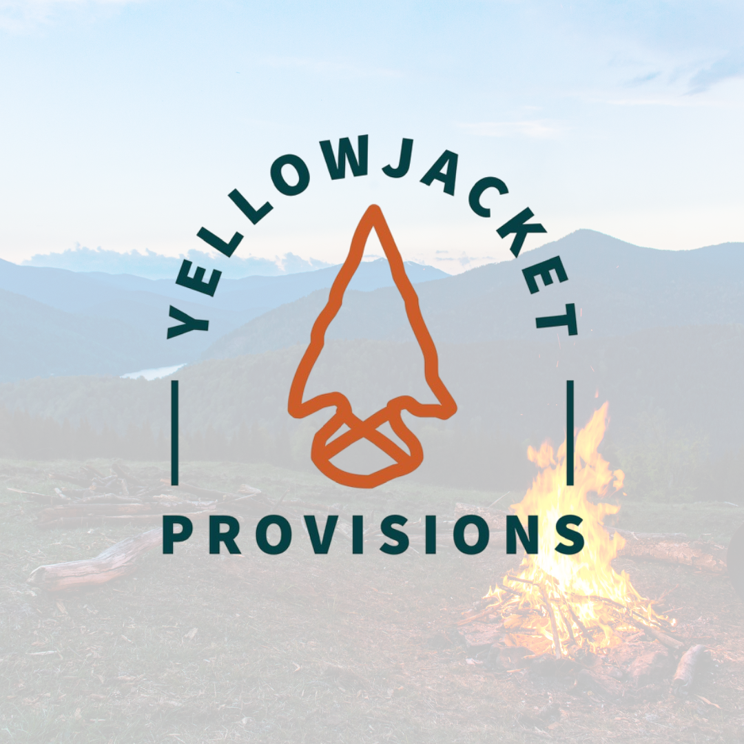 Logo for Yellowjacket Provisions with a stylized arrowhead design, set against a mountain landscape background with a campfire in the foreground.