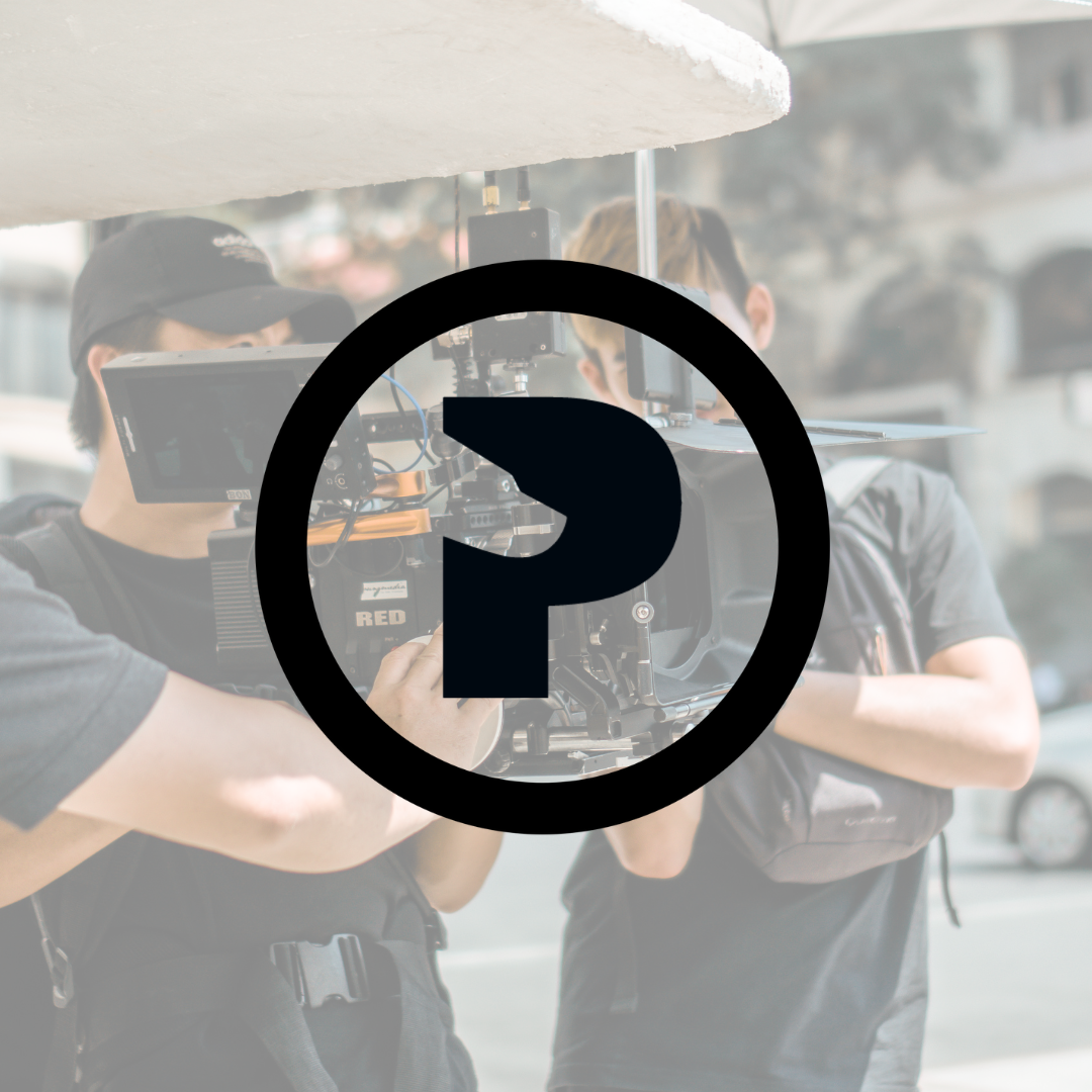 Filmmakers with RED camera behind opaque logo