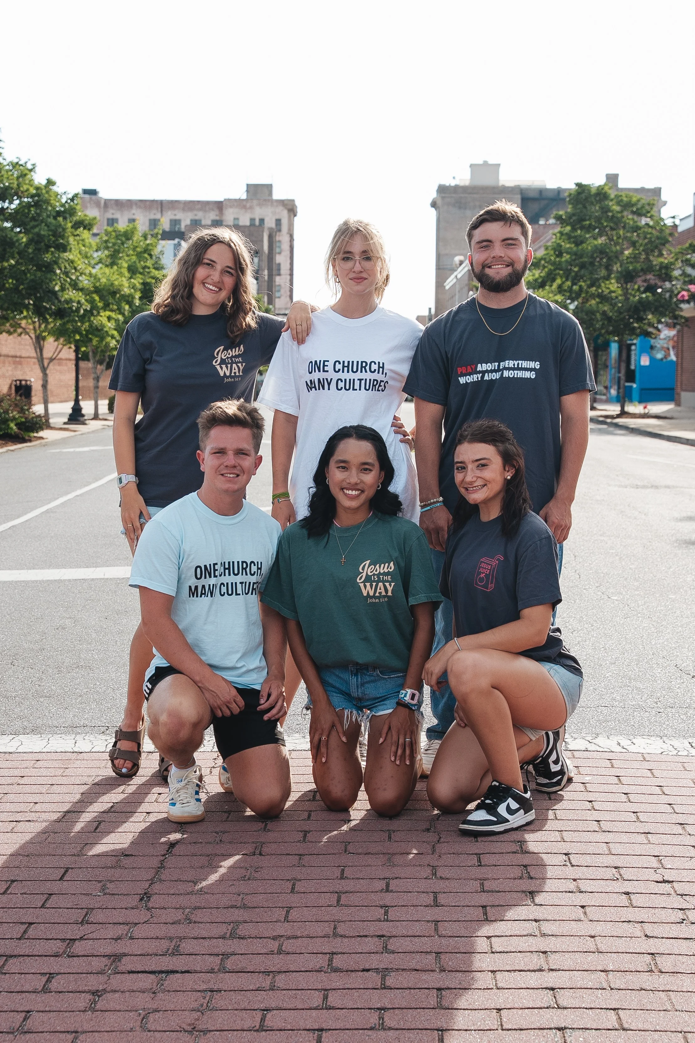 Group of friends wearing Hope Awake Christian clothing on a city street.