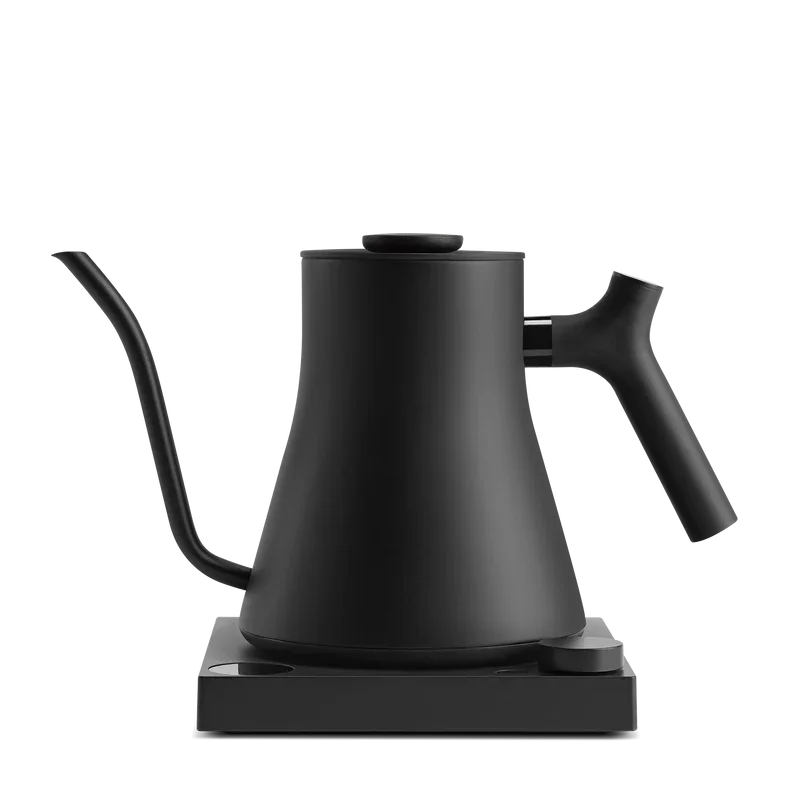 A black electric kettle with a matte finish placed on a matching black base.