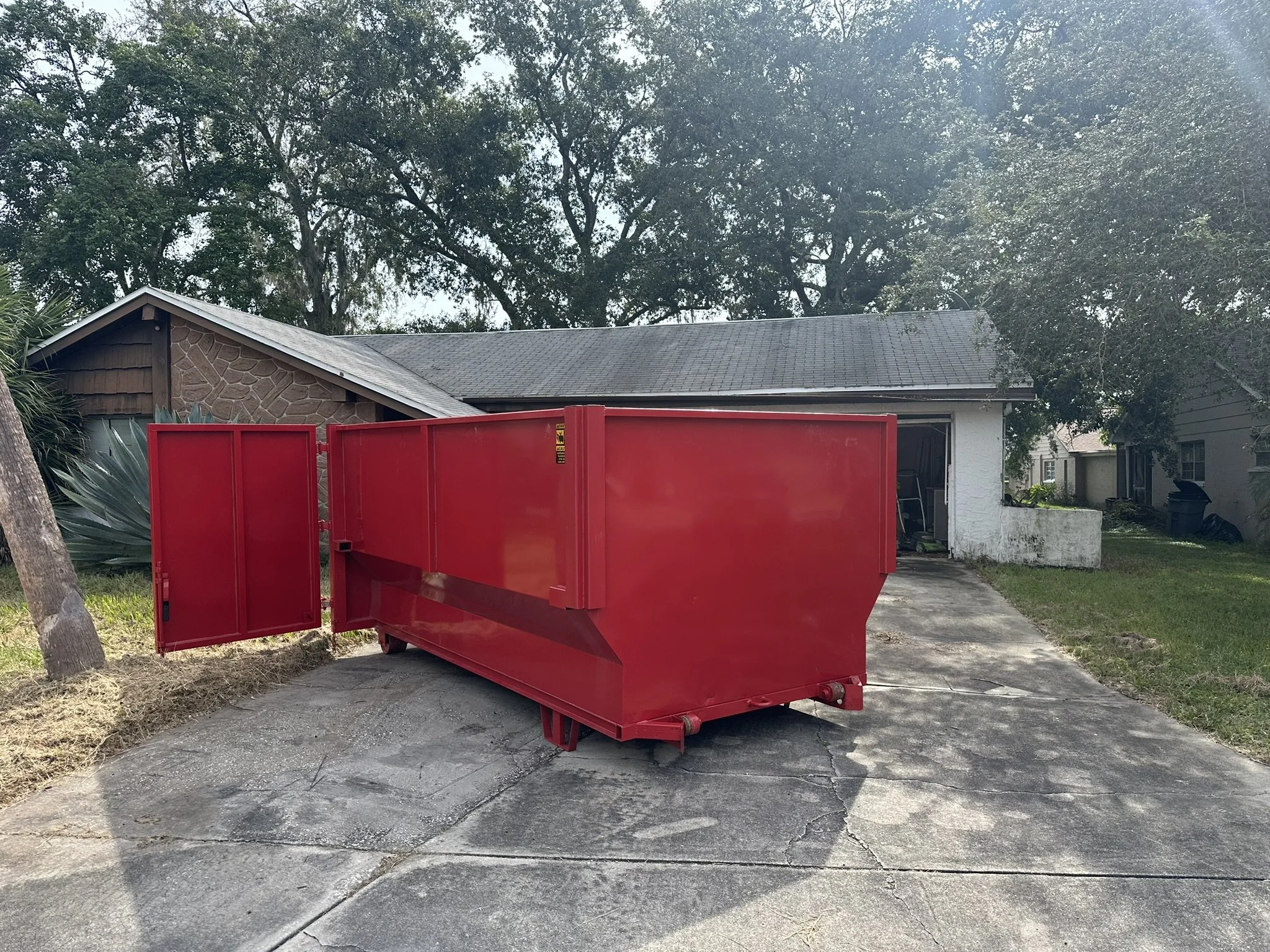 16-yard roll-off dumpster rental placed on a residential driveway in Hudson, Florida