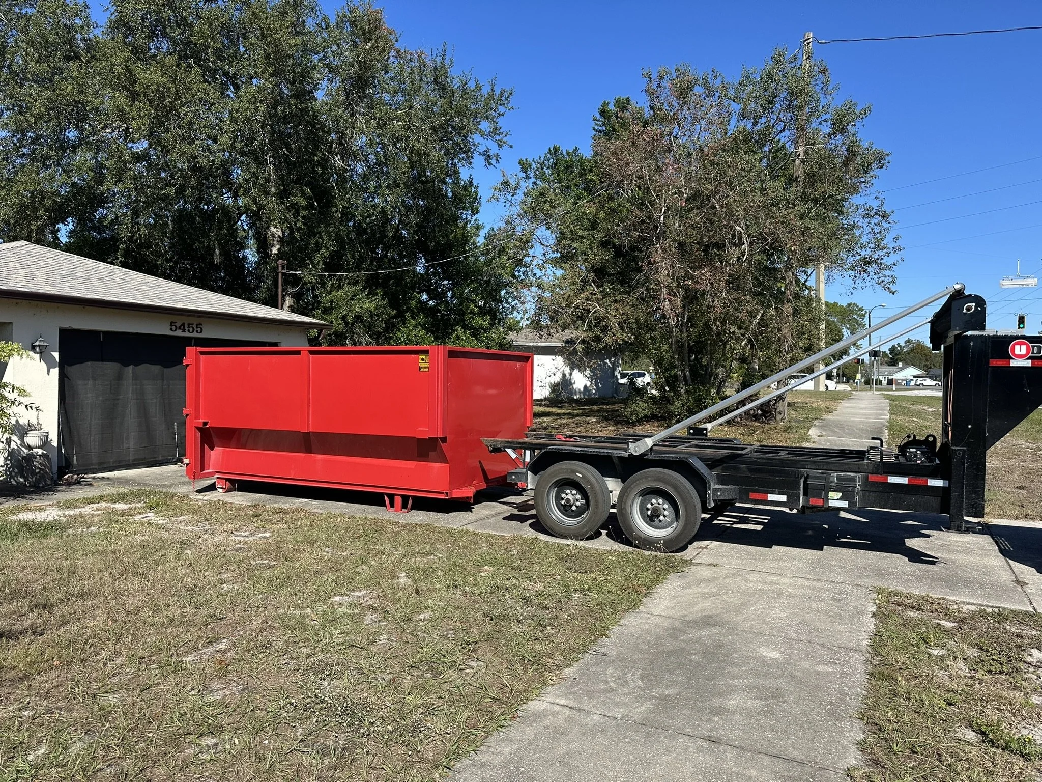 12-yard roll-off dumpster rental placed in a driveway in Seven Hills, Spring Hill, FL.