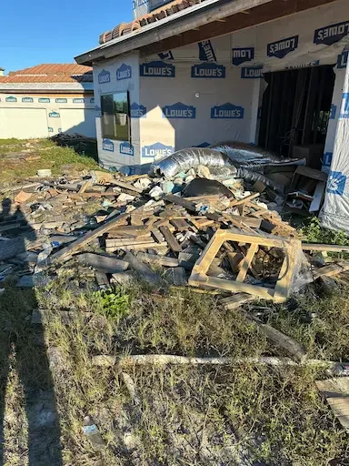 Construction debris removal in Spring Hill, FL with wood and drywall loaded by Five Alarm Dumpsters