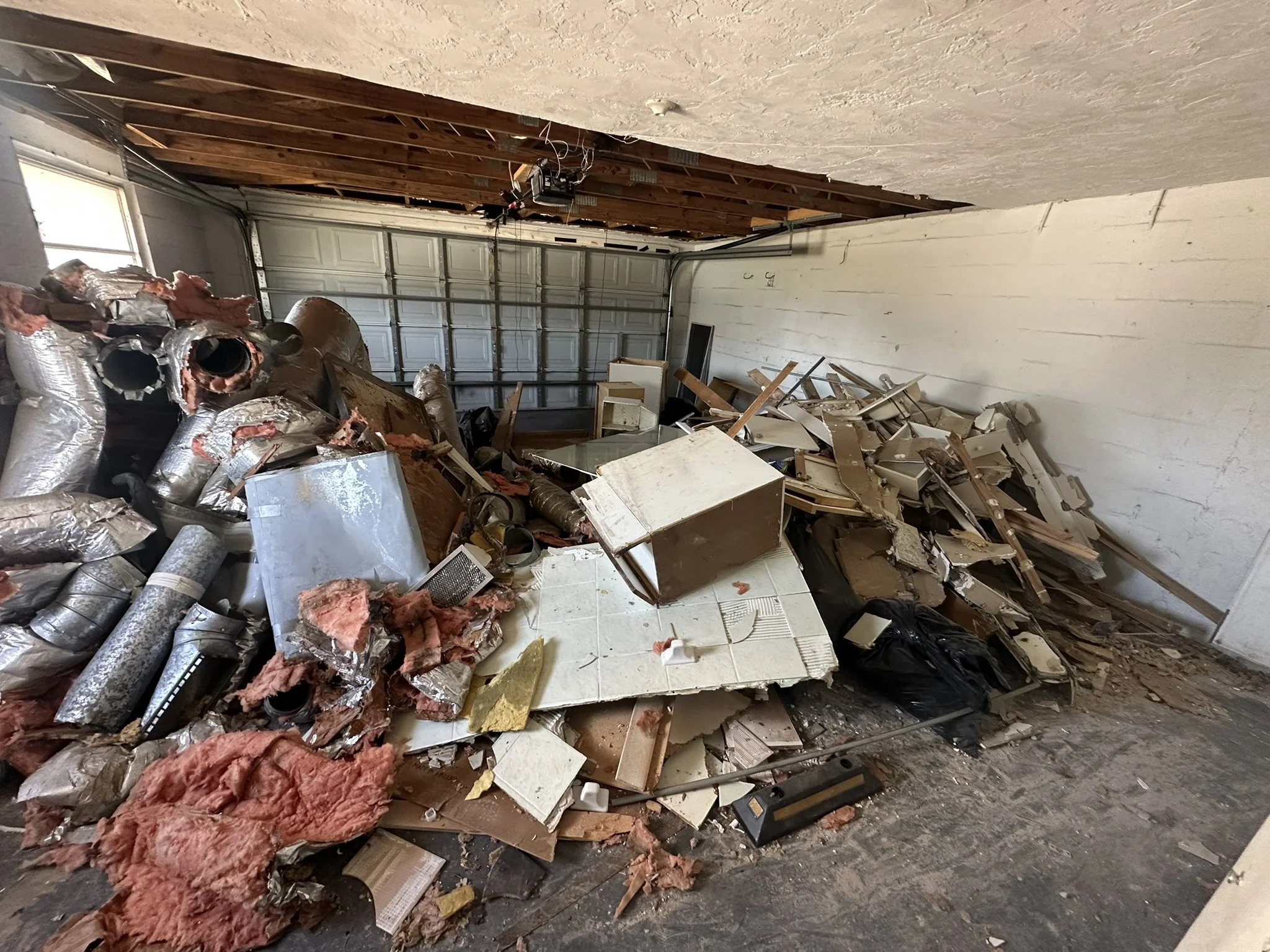 Construction debris piled in a garage during a cleanout in Hudson, Florida