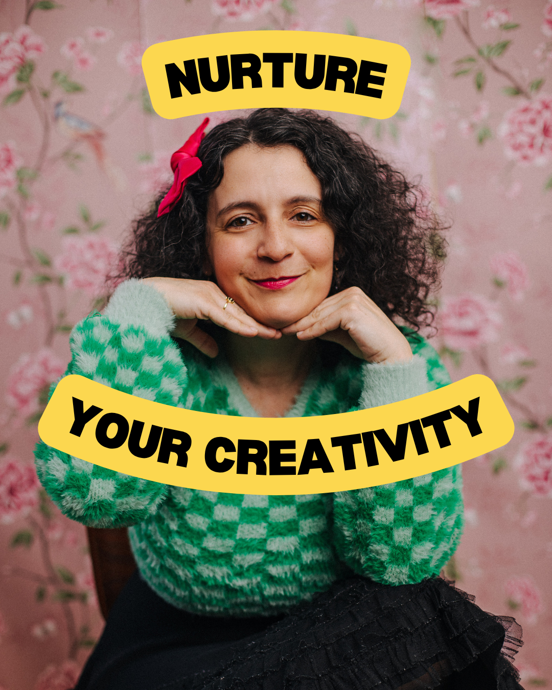 A woman with curly brown hair, wearing a pink bow and a green checkered fuzzy sweater, sits in front of a pink floral background. She rests her chin on her hands and smiles. Overlaid on the image are yellow banners with bold black text that read 'NURTURE' and 'YOUR CREATIVITY'.
