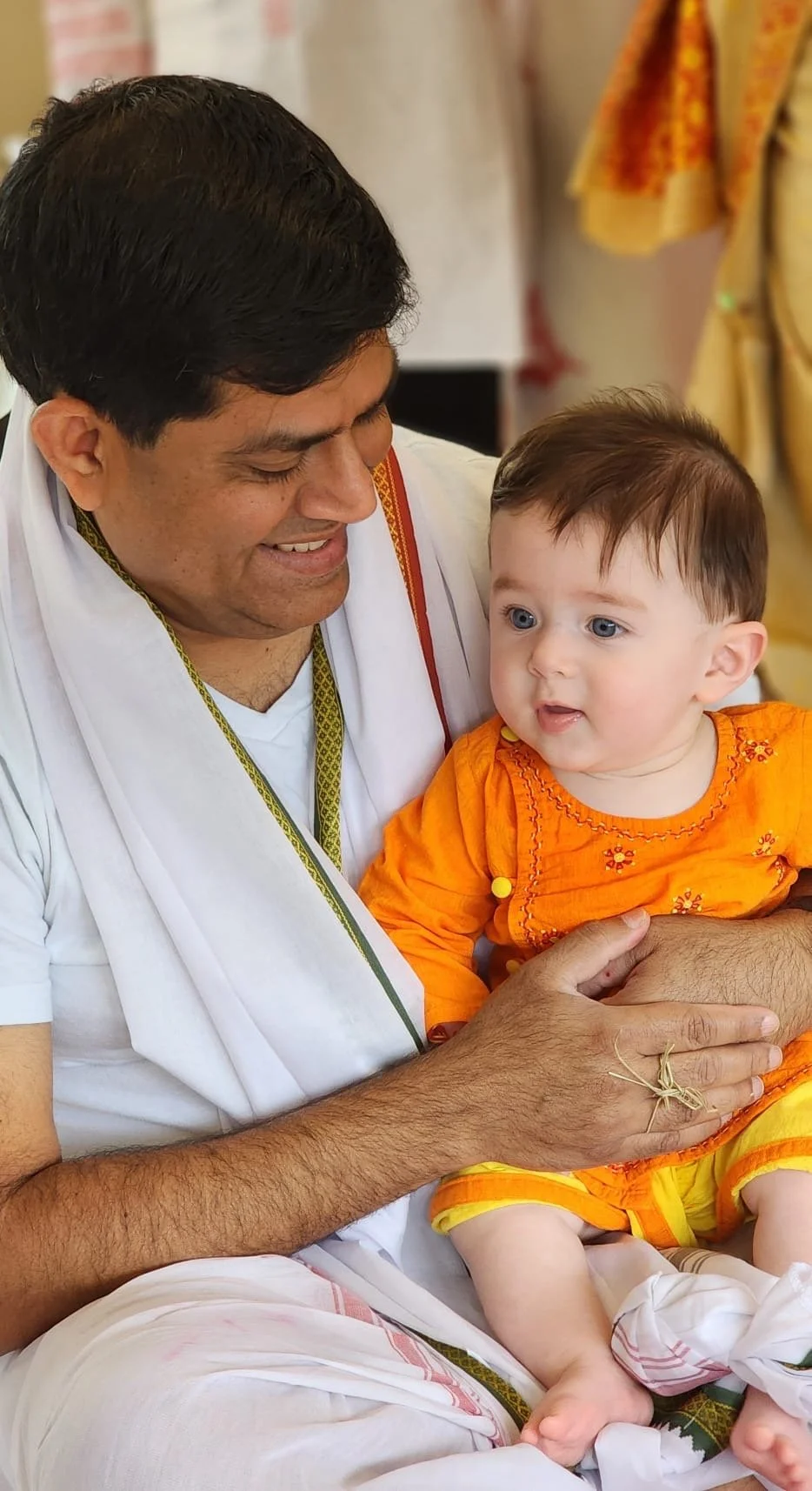 A grandfather with his grandson who is celebrating his annaprashan or Bengali Hindu rice ceremony in San Diego, California.