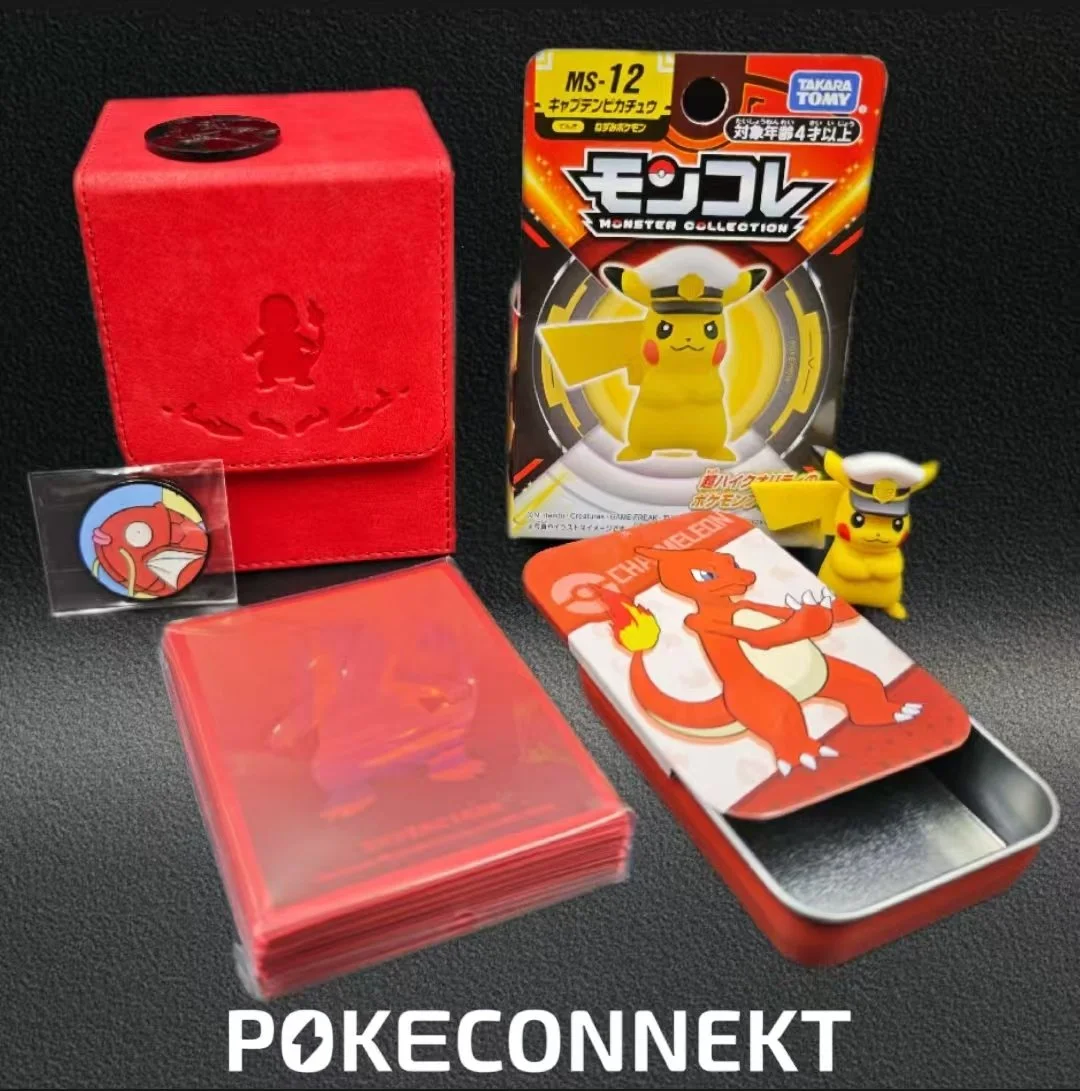 A collection of Pokémon-themed items including a red PokeConnEKT box, a Pikachu figure wearing a hat, Pokémon trading card, sticker of Magikarp, a card featuring Charizard, and a blister pack of Pokémon capsules, all arranged on a black surface.