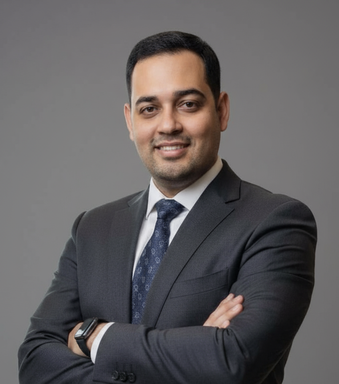 A mountain landscape with snow-capped peaks, green hills, and a modern building with wood and stone exterior in the foreground.